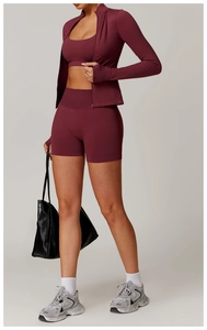 Three-piece seamless yoga set in burgundy featuring high-waist shorts and zip-up jacket
