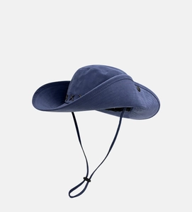 Detail of dark blue cowboy hat featuring cross-stitch embroidery and adjustable chin strap