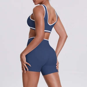 Detail view of navy blue yoga set showing high-elasticity fabric and contrast piping