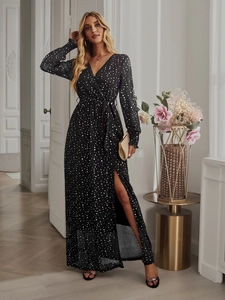 Detail of black V-neck maxi dress with white polka dots featuring waist tie and high slit