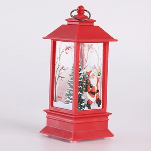 Detail view of red LED Christmas lantern with festive Santa Claus and pine tree patterns