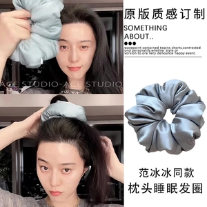 Detailed view of soft silk scrunchie for hair protection during sleep in silver grey