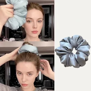 Detailed view of soft silk scrunchie for hair protection during sleep in silver grey