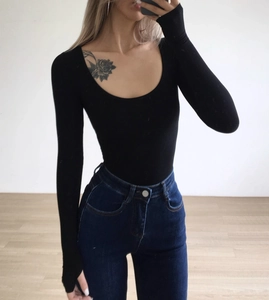 Mirror selfie showing the close-up texture of a black U-neck long sleeve bodysuit