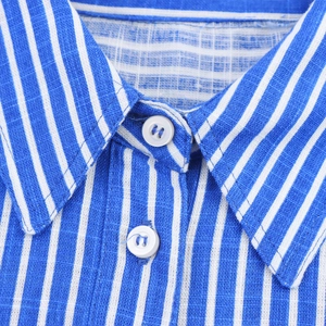 Close-up of blue and white striped cotton-linen shirt collar with white buttons