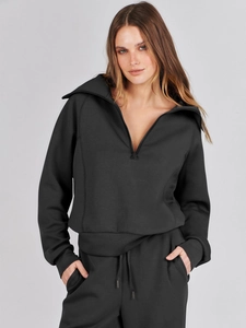Detailed texture of black long sleeve zip-up sweatshirt and loose sweatpants set
