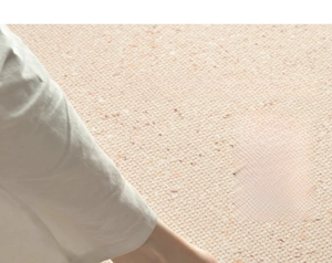 Close-up of thick beige woven carpet showing soft texture and resilient knit material