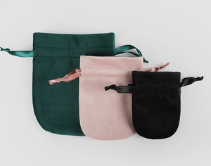 Three premium velvet drawstring pouches in dark green, pink, and black colors