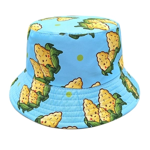 Detail of blue sun hat showing cartoon corn print and reinforced stitching on the brim