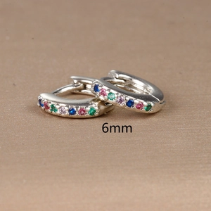 Macro shot of 6mm silver hoop earrings with multi-colored cubic zirconia gemstones