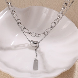 Double-layer stainless steel necklace featuring a silver bean and rectangle pendant
