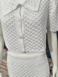 Dettaglio di completo due pezzi in maglia bianca con ricami a uncinetto traforati