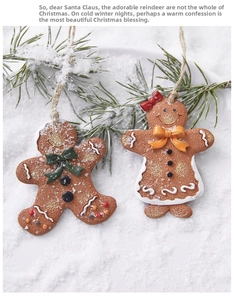 Detail of gingerbread man and woman ornaments with white icing and festive bows