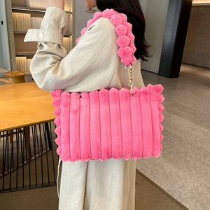 Pink faux fur tote bag with plush ball shoulder strap and stylish gold chain accents