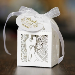 White laser-cut wedding favor box with Mr & Mrs hollow design and white organza ribbon