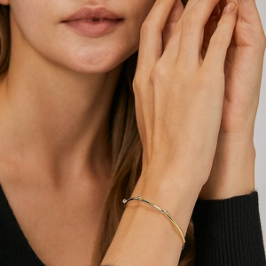 Elegant gold-plated adjustable brass bangle featuring three round white zircon stones