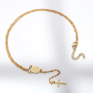 Golden rosary necklace with orange beads featuring a Virgin Mary medal and cross pendant