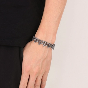 Close-up of vintage dark silver snake chain bracelet with antique snake head charms