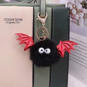 Halloween black faux mink fur bat keychain with red glitter wings on a handbag