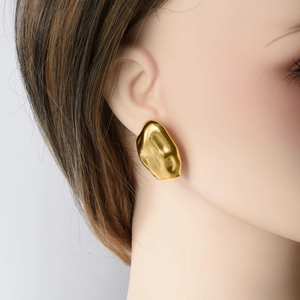 Modern 18k gold irregular stainless steel earrings shown on a model with metallic finish