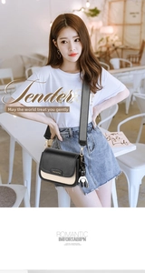 Close-up of contrast crossbody bag with wave pattern wide strap and bear charm