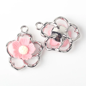 Close-up of pink flower charm for jewelry making showing front and back details