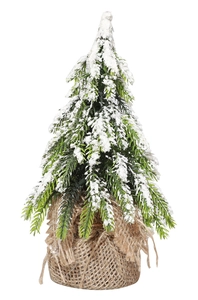 Close-up of mini flocked Christmas tree with realistic snow and rustic burlap base