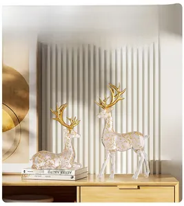 Close-up of luxury Nordic elk statues with transparent gold foil and golden antlers