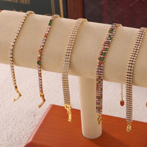 Elegant multi-color tennis bracelets with single and triple row zircon stones on a T-stand