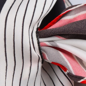Macro detail of striped fabric showing precise stitching and woven texture of the garment