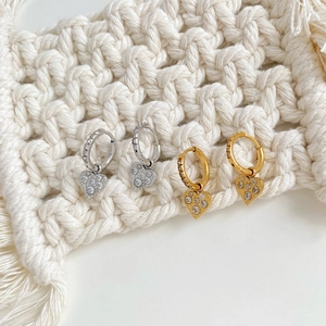 Fashionable sparkling gold and silver heart hoop earrings with pave crystals on macrame