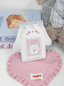 Close-up of a white bunny-shaped PVC desk calendar photo album with rings