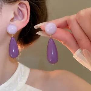 Elegant purple acrylic teardrop earrings with silver needle and gold metal accents