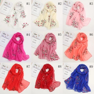Detail view showing nine colors of floral embroidered chiffon scarves in a grid layout