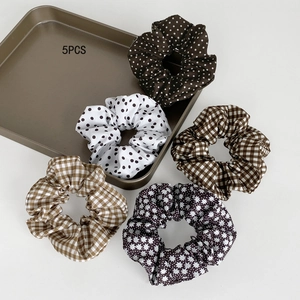 5-piece set of scrunchies with retro polka dots and plaid patterns on metal tray