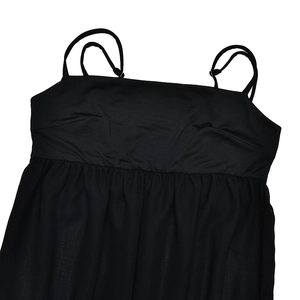 Detail of black mini dress with thin straps, pleated bust design, and breathable fabric