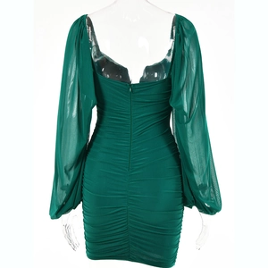Detail view of green V-neck mini dress showing ruched fabric and sheer lantern sleeves