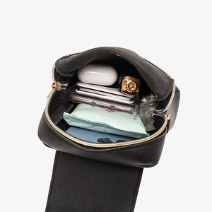 Minimalist black woven phone bag showing interior capacity with phone and lipstick