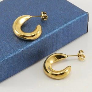 Minimalist 18K gold-plated C-shaped stainless steel earrings on a blue jewelry box
