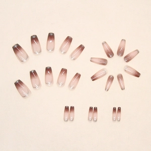 Mocha gradient press-on nails with gold foil trim in a long coffin shape set