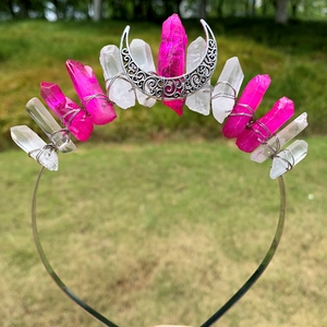 Detailed view of pink and white crystal raw stones with a silver moon crown headband