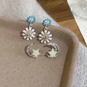 Elegant daisy flower and moon star earrings set with gold plating and sparkling crystals