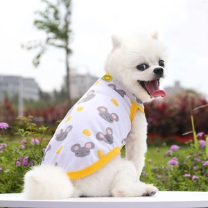 Close-up of a white pet vest with cartoon mouse print and yellow piping on a Pomeranian