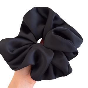 Oversized black satin hair scrunchie with a silky finish for a French ballet style aesthetic
