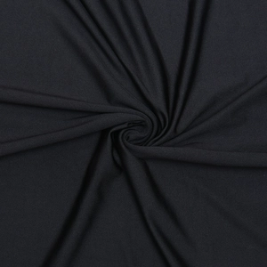 Macro shot of black ribbed stretch fabric with soft spiral folds and fine texture