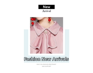 Detail of pink satin blouse collar with lace trim, ribbon tie, and vintage button