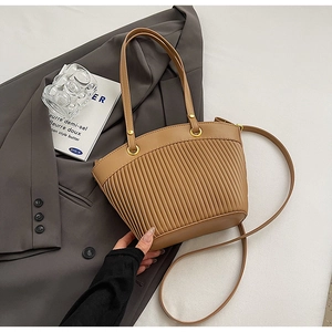 Detailed view of brown pleated bucket bag with shoulder strap and stylish PU leather texture