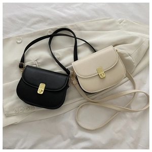 Black and beige retro saddle bags featuring elegant gold buckles and smooth faux leather