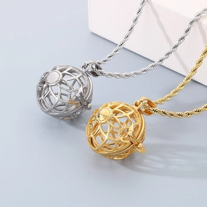 Detail of hollow sphere pendant necklaces in gold and silver finish with twisted chains
