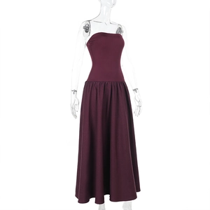 Detail view of deep red strapless dress with slim waist and flared large swing skirt